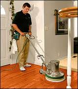 professional cleaner buffing hardwood floor